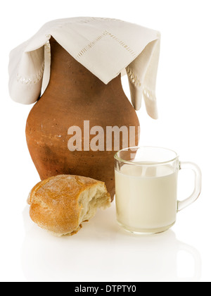 Old clay jug, bread and a mug of milk on white background Stock Photo