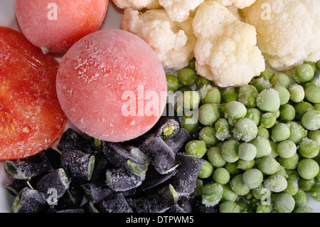 heap of frozen tomato, asparagus, peas and cauliflower Stock Photo