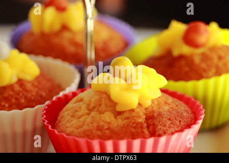 Vanilla cupcakes with lemon frosting on a cake stand Stock Photo
