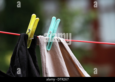 Clothes pegs on line on washing day. Stock Photo