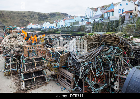 Lobster or crab pots stacked on the quayside at Staithes, North Yorkshire, UK ready for use. Stock Photo