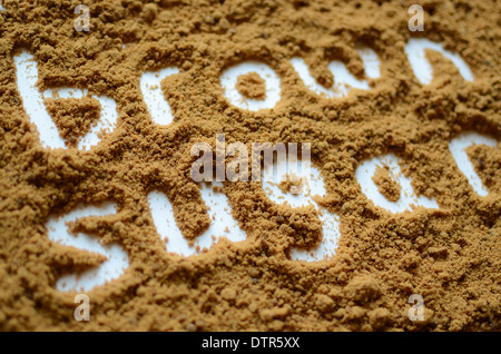 The words 'brown sugar' showing in brown sugar. Stock Photo