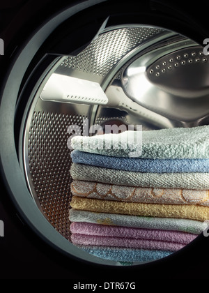 Stacked clean towels in the washing machine. Stock Photo