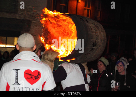 A man carries a flaming tar barrel on his shoulders. Stock Photo