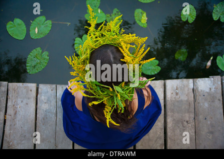 girl by the lake with a wreath on head Stock Photo