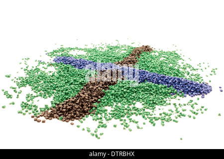 Colored plastic polymer granules in cross shape, white background Stock Photo