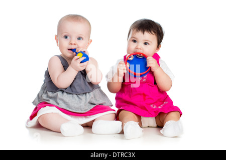 Funny babies girls with musical toys Stock Photo