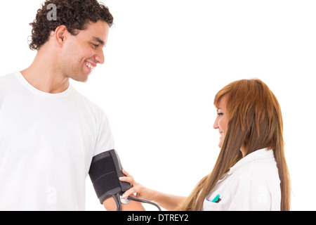 professional nurse or doctor measures the blood pressure of a satisfied and smiling patient Stock Photo