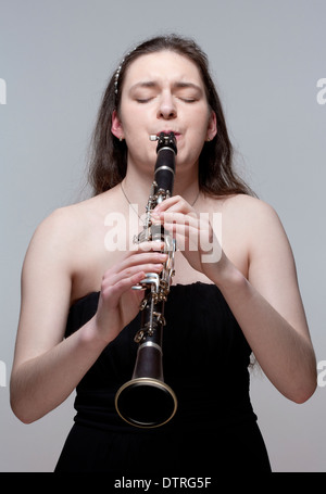 Portrait of Young Female Musician Playing Clarinet Stock Photo