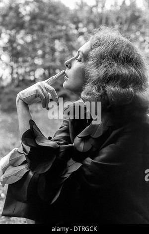 Sixties fashion model portrait with black coat Stock Photo