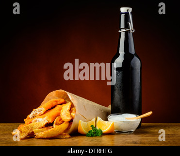 still life with traditional fish and chips menu, lemons, dip sauce and beer bottle Stock Photo