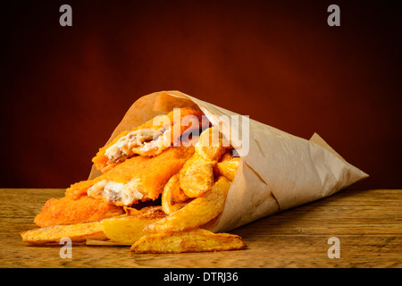 still life with traditional fish and chips wrapped in paper Stock Photo