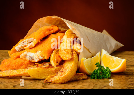 still life with traditional fish, potato chips and lemons Stock Photo