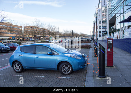 Electric car at charging point Stock Photo