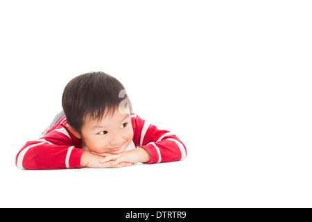 A cute boy is thinking on the floor in studio Stock Photo
