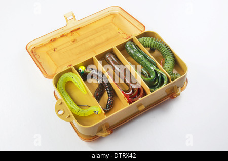 Bass bait, or old fishing tackle box with rubber worms and tubes. Stock Photo