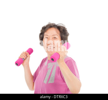 smiling senior woman working out with dumbbells in studio Stock Photo