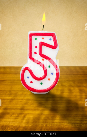 Burning birthday candle number 5 Stock Photo