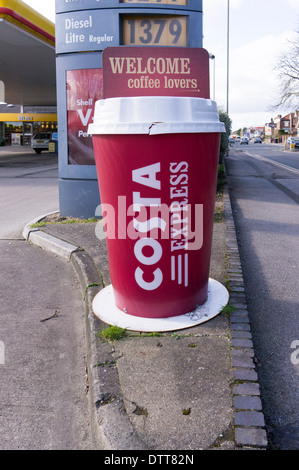 Giant Costa roadside coffee cup advertising display outside UK Shell petrol service station Stock Photo