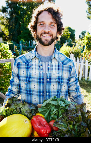 Caucasian man harvesting vegetables in garden Stock Photo
