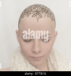 Caucasian woman with bald tattooed head Stock Photo
