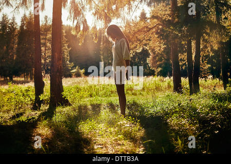 Caucasian girl walking in forest Stock Photo