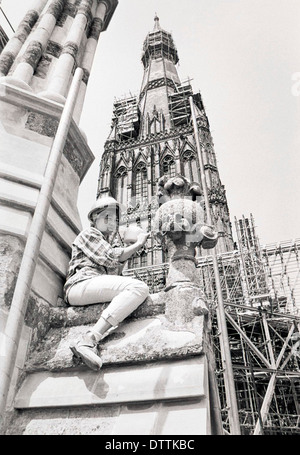 A female stonemason gets to work on a pinnacle on the West Front of Salisbury Cathedral in 1990. Stock Photo