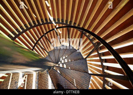 Metal modern spiral staircase details with wooden structure Stock Photo