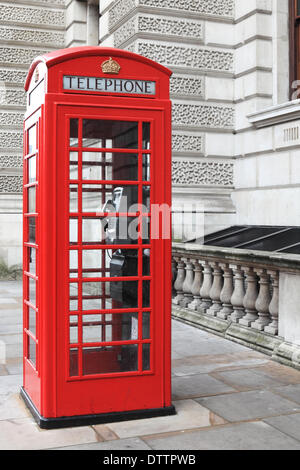 British red phone box on a London street Stock Photo