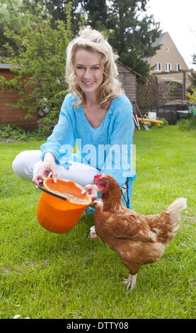 woman feeding chicken Stock Photo