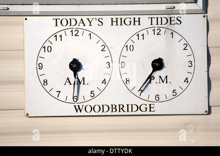 Two clocks showing times of high tides at Woodbridge, Suffolk, England Stock Photo