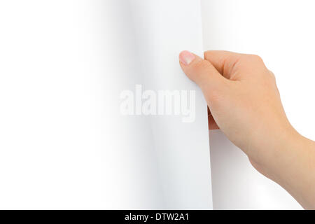 Hand turning paper page Stock Photo