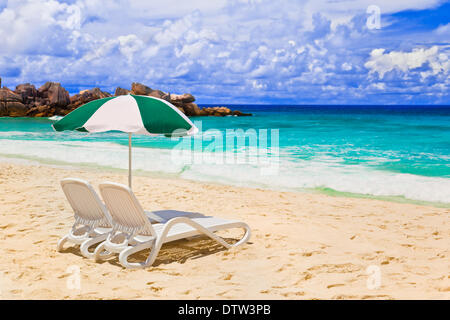 Chairs and umbrella at tropical beach Stock Photo