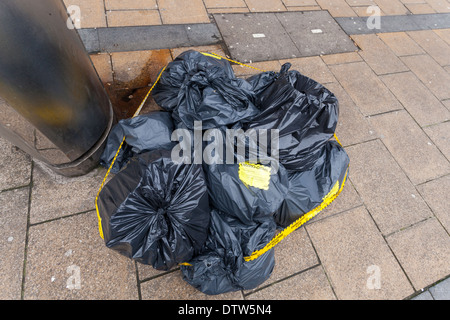 Environmental crime scene. Fly tipping or illegal dumping of waste. Bags of rubbish left on a street in Sheffield city centre, England, UK Stock Photo