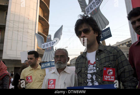 Members of NGO, Citizens Trust Against Crime (CTAC) are demonstrating in favor of Police Department while opposing terrorism, near Metro Pole Hotel in Karachi on Monday, February 24, 2014. Stock Photo