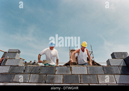 Bricklayers work on the construction of a new house. Stock Photo