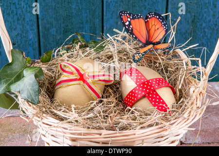 Two Golden Goose Eggs In A Hay Filled Basket With Bow And Ivy Stock Photo Alamy
