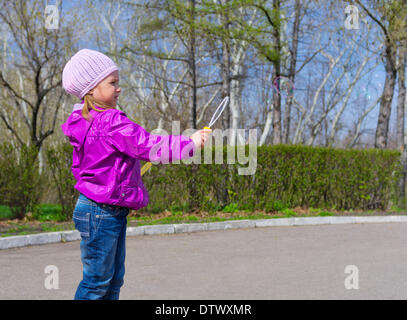Little girl with soap bubbles Stock Photo