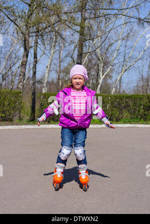 Little girl skating on roller skates Stock Photo