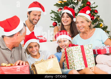 Happy family at christmas swapping gifts Stock Photo