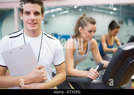 Spinning class instructor holding clipboard Stock Photo