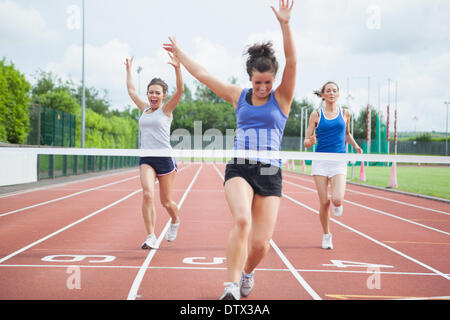 Athlete celebrates race win at finish line Stock Photo