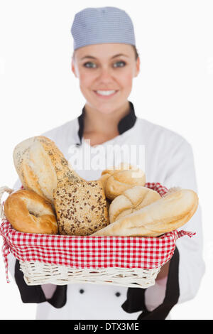 Female chef with fresh breads in basket Stock Photo