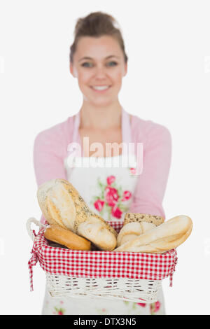 Happy young woman with bread basket Stock Photo