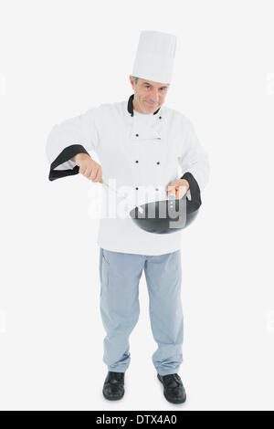 Confident chef cooking food Stock Photo