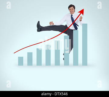 Smiling man in suit jumping over the graph Stock Photo