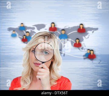 Blonde woman looking through the magnifier Stock Photo
