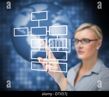 Businesswoman pressing button on touch screen Stock Photo