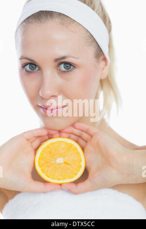 Attractive woman holding slice of orange Stock Photo