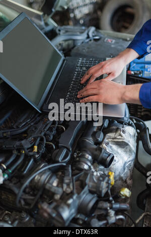 Car mechanic using laptop Stock Photo